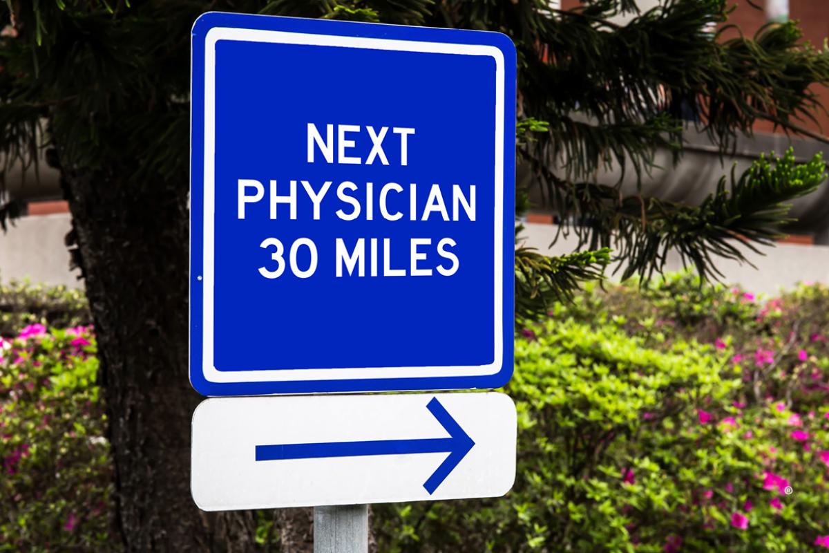 Sign post showing next physician 30 miles with arrow. 